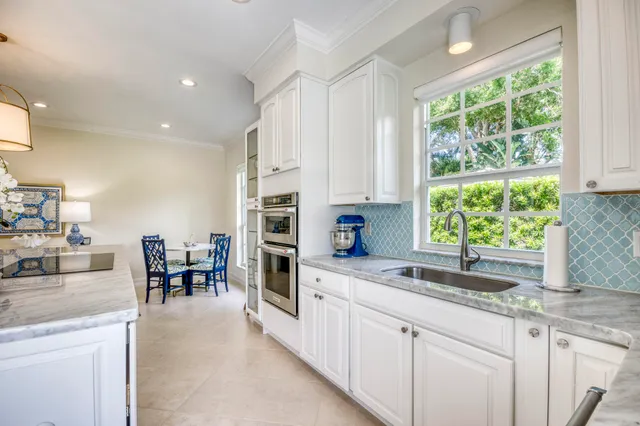 a kitchen with granite countertop sink and cabinets