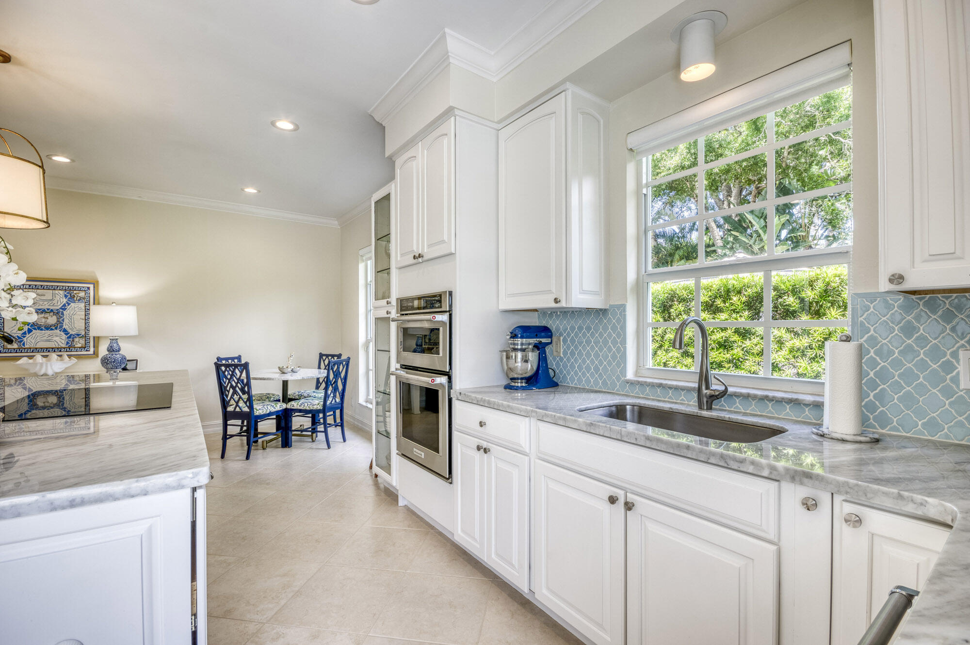 10182 Southeast Acorn Way Jupiter, FL 33469 - Photo 12 of 38 a kitchen with granite countertop sink and cabinets