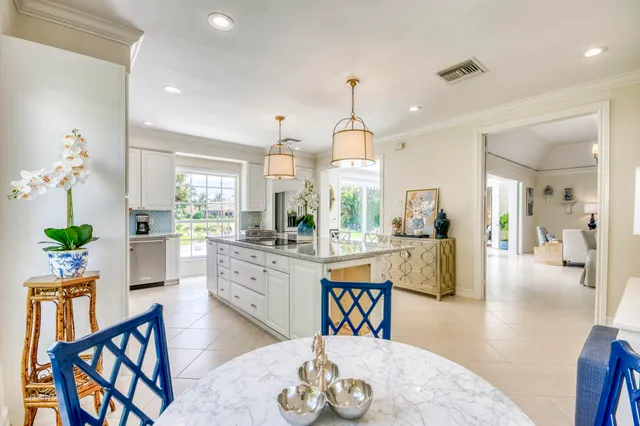 a view of a dining room and livingroom with furniture wooden floor a chandelier