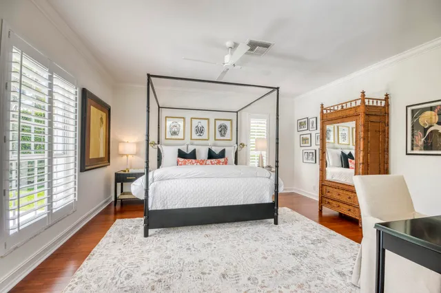 a bedroom with a large bed and a chandelier