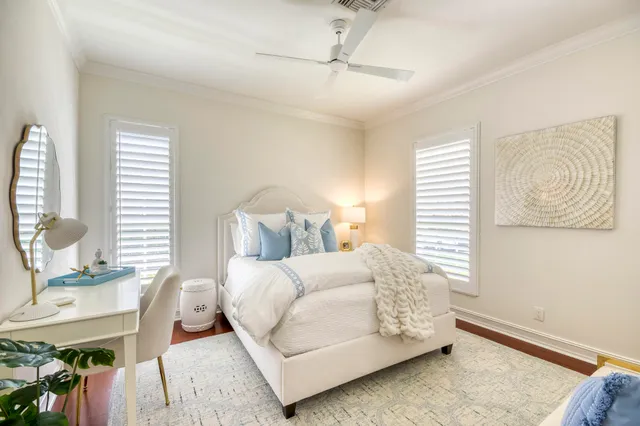 a bedroom with a bed a table window and couch