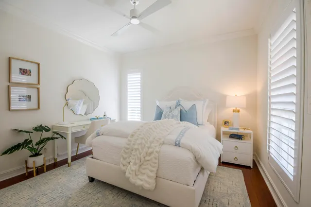 a bedroom with a large bed and a chandelier