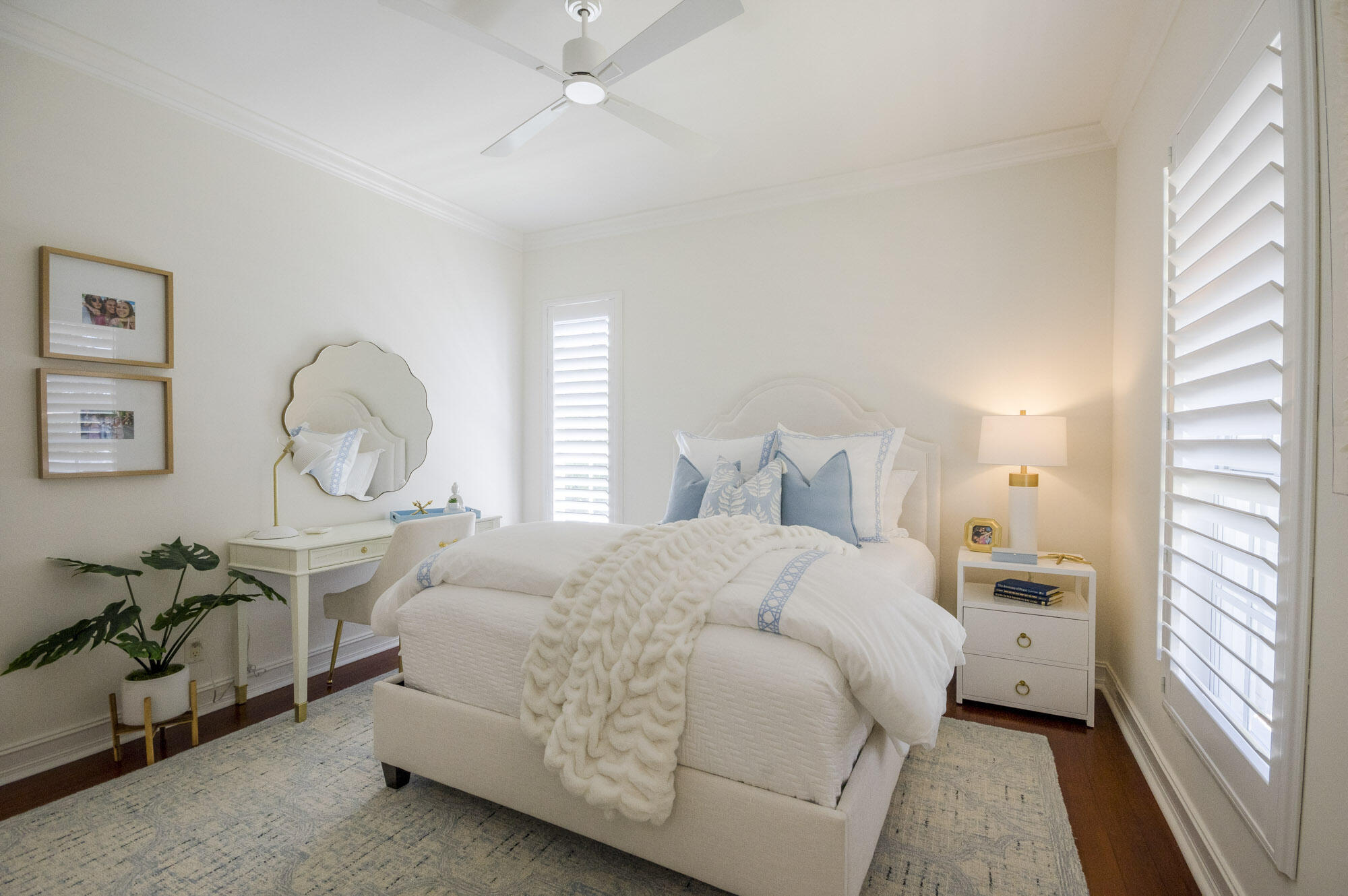 10182 Southeast Acorn Way Jupiter, FL 33469 - Photo 19 of 38 a bedroom with a large bed and a chandelier