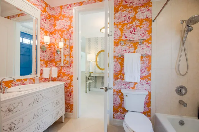a bathroom with a sink a toilet and shower curtain