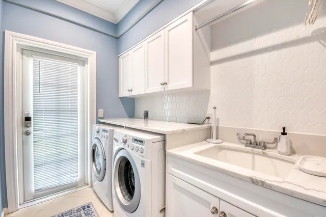 a view of a kitchen with sink washer and dryer