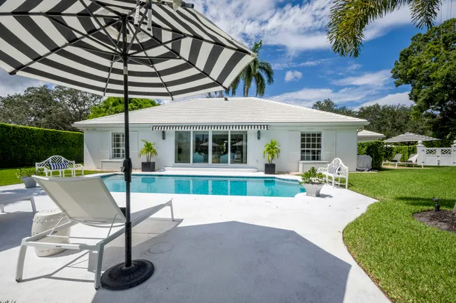 a front view of a house with garden and patio