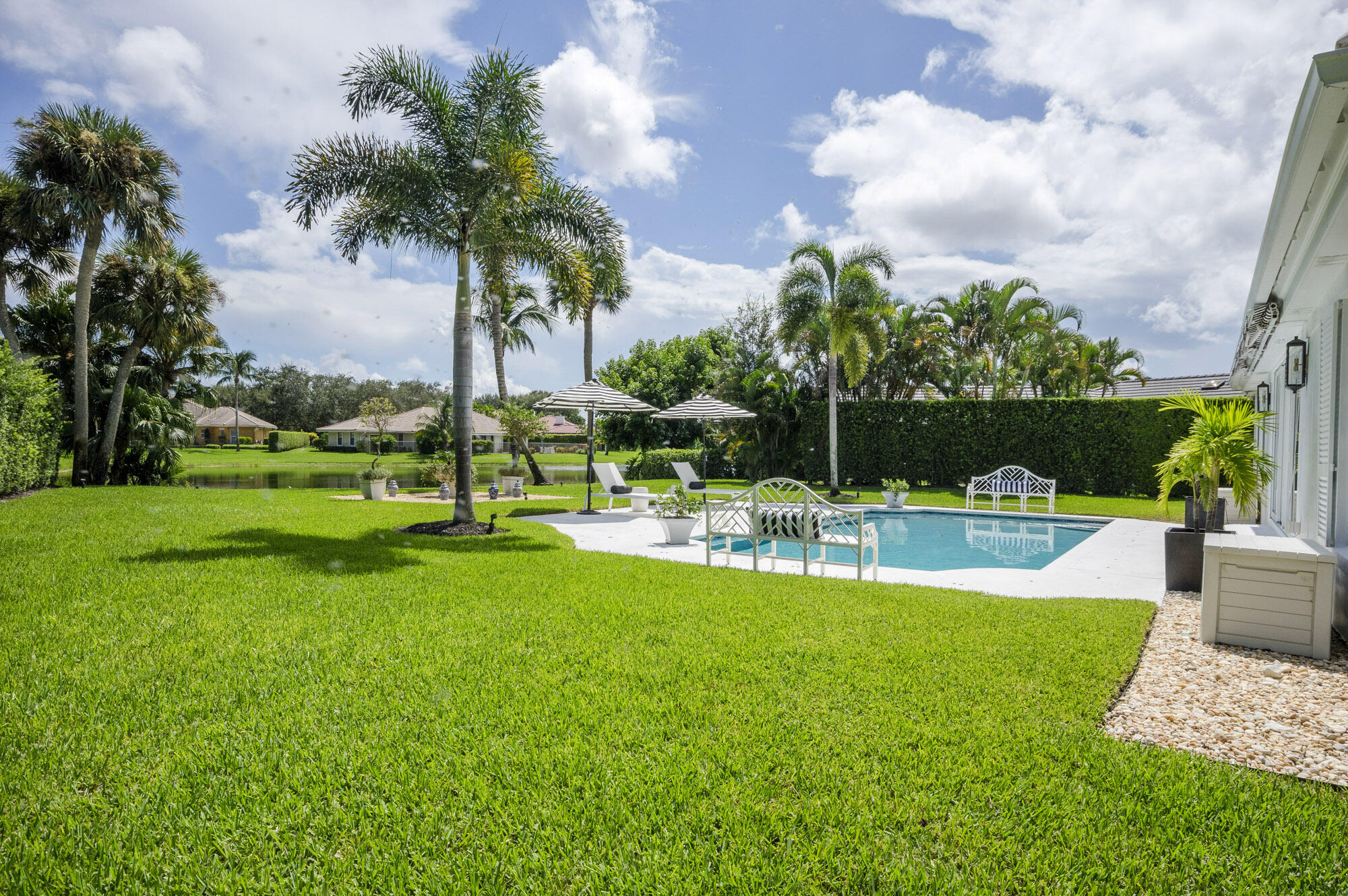 10182 Southeast Acorn Way Jupiter, FL 33469 - Photo 30 of 38 a view of a chair and tables in the garden