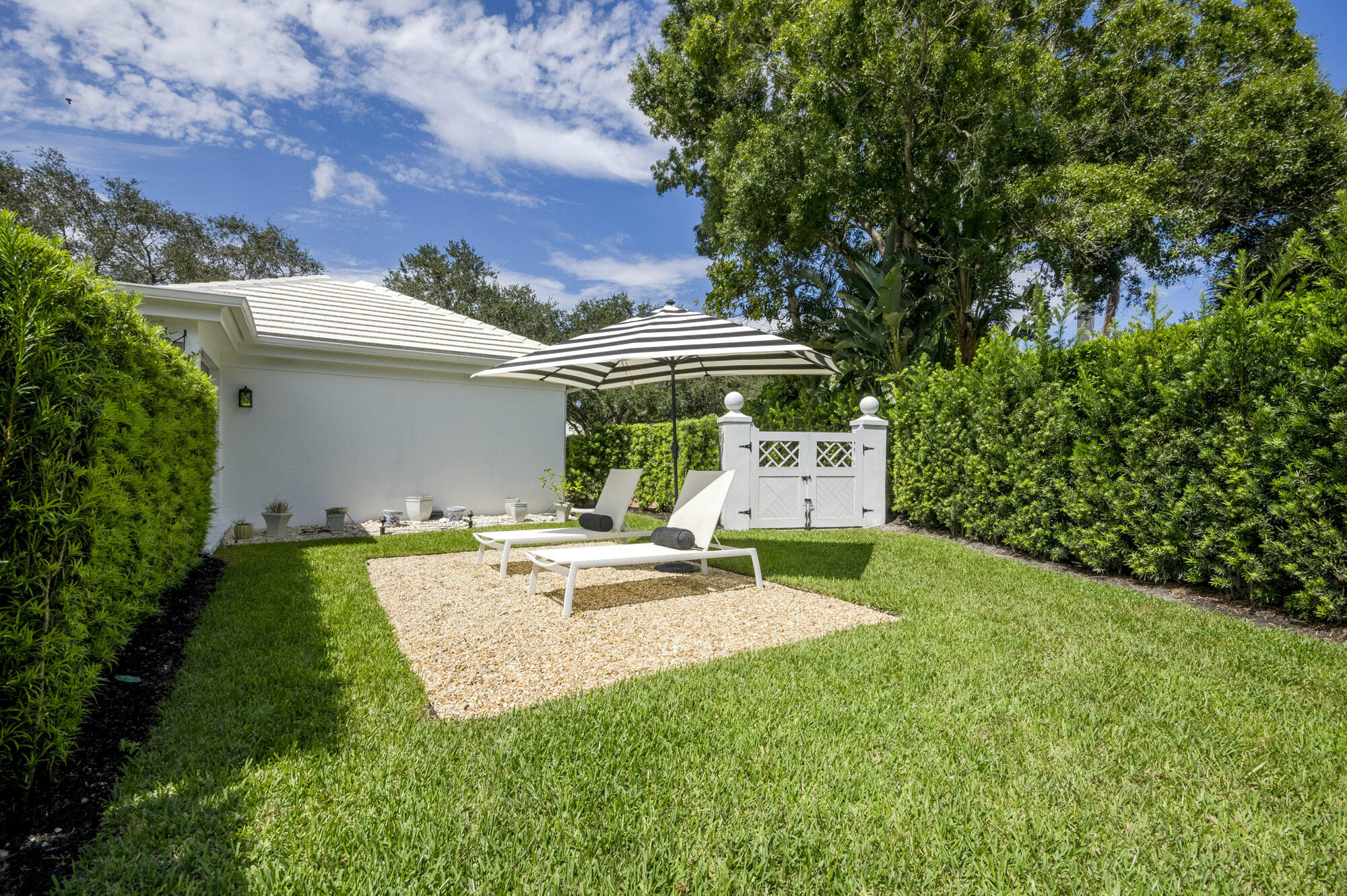 10182 Southeast Acorn Way Jupiter, FL 33469 - Photo 31 of 38 a view of a house with backyard and sitting area