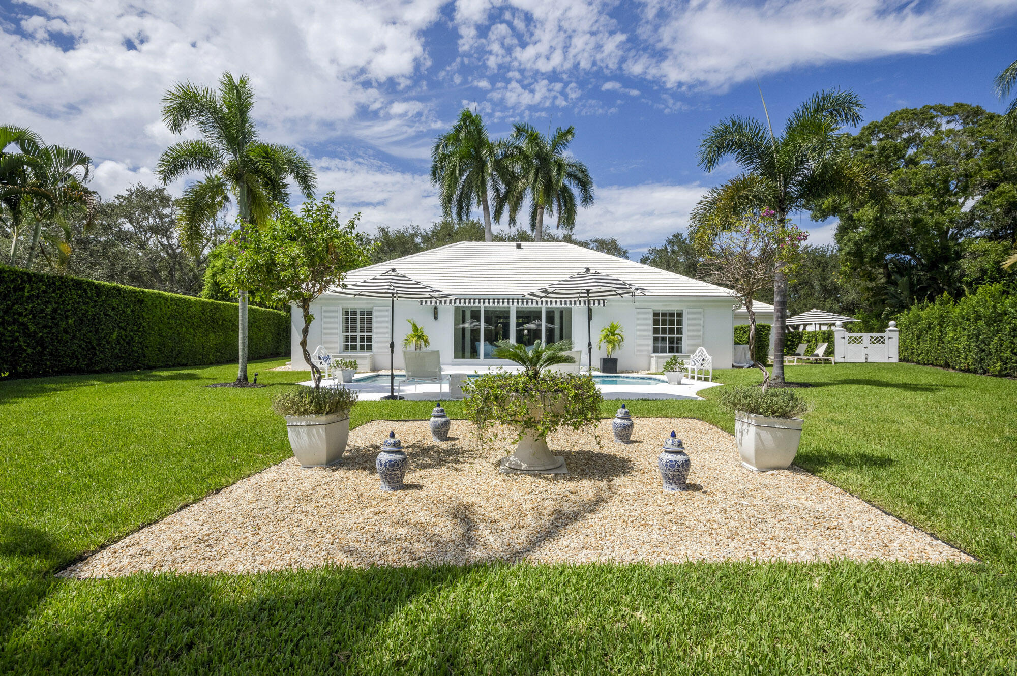 10182 Southeast Acorn Way Jupiter, FL 33469 - Photo 34 of 38 a front view of a house with garden and porch