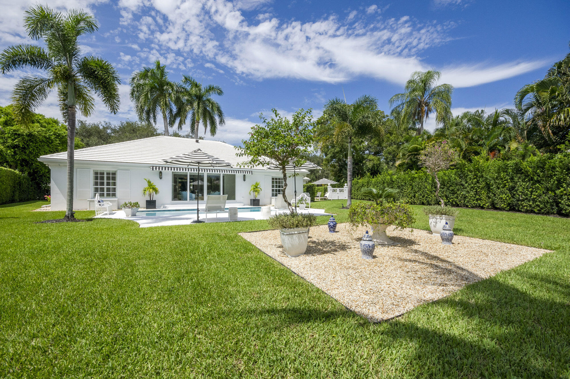 10182 Southeast Acorn Way Jupiter, FL 33469 - Photo 36 of 38 a view of a house with swimming pool and a big yard