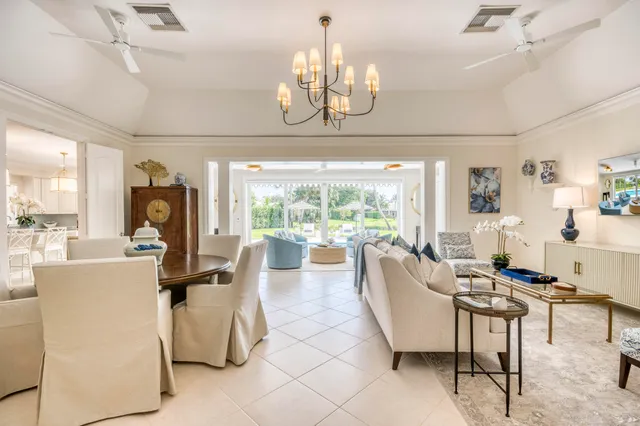 a living room with fireplace furniture and a chandelier