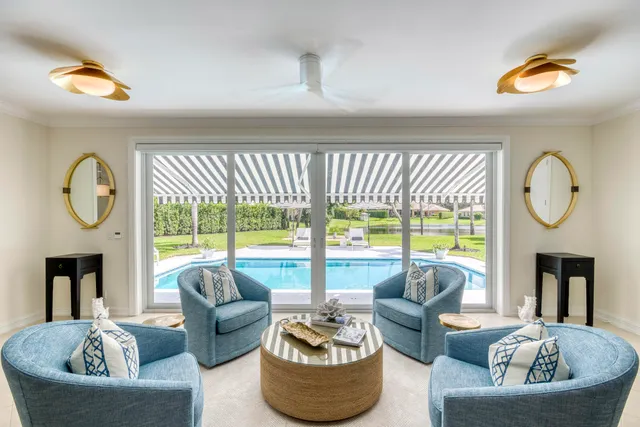 a living room with furniture a fireplace and a large window