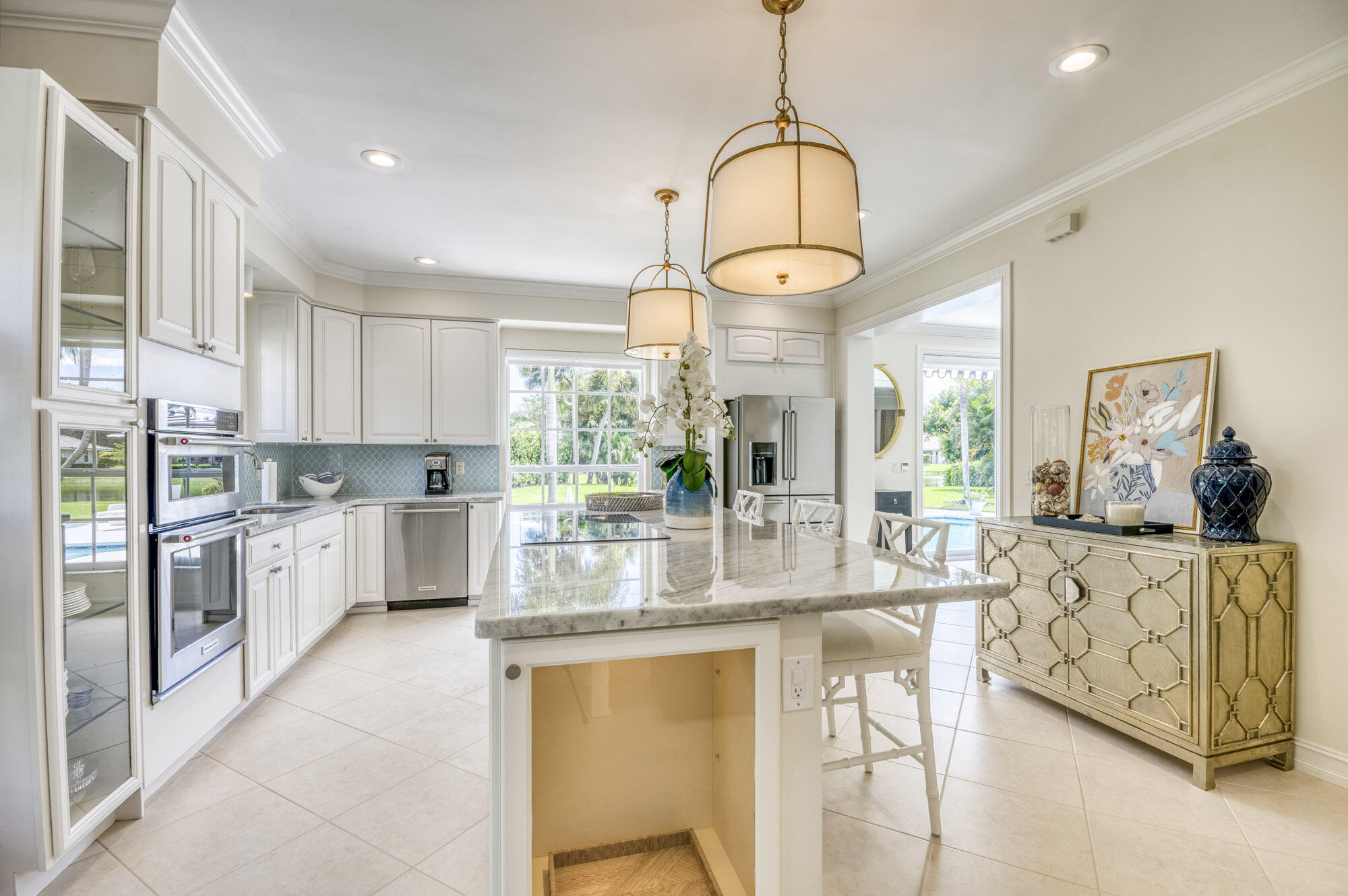 10182 Southeast Acorn Way Jupiter, FL 33469 - Photo 9 of 38 a kitchen with stainless steel appliances granite countertop a stove and refrigerator