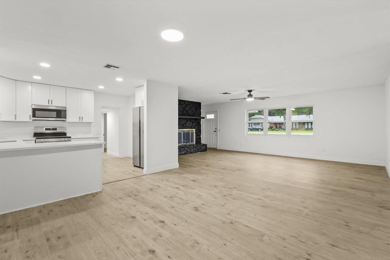 603 Southwest 14th Street Okeechobee, FL 34974 - Photo 11 of 41 a view of a kitchen with microwave and refrigerator