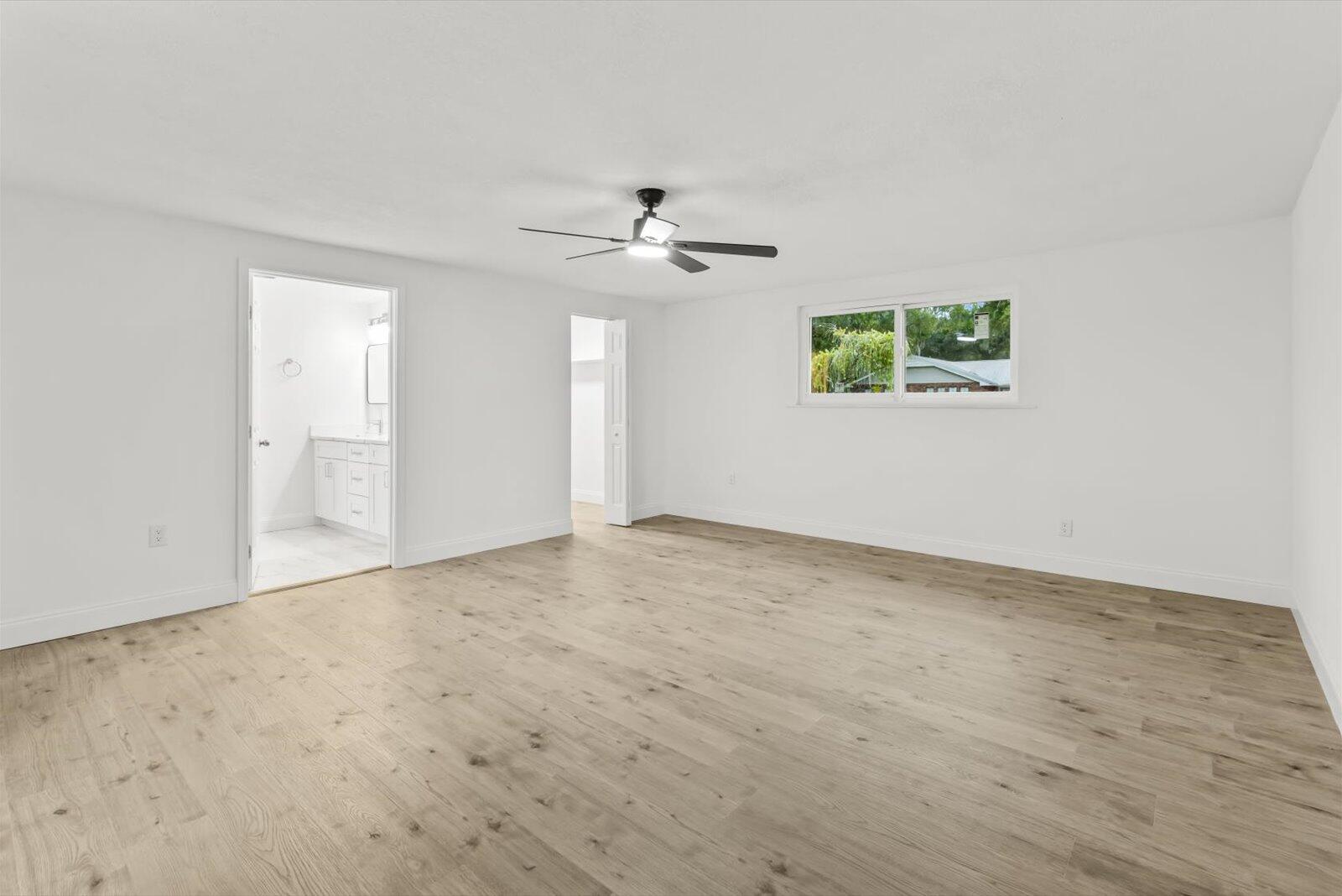 603 Southwest 14th Street Okeechobee, FL 34974 - Photo 17 of 41 an empty room with fan and windows