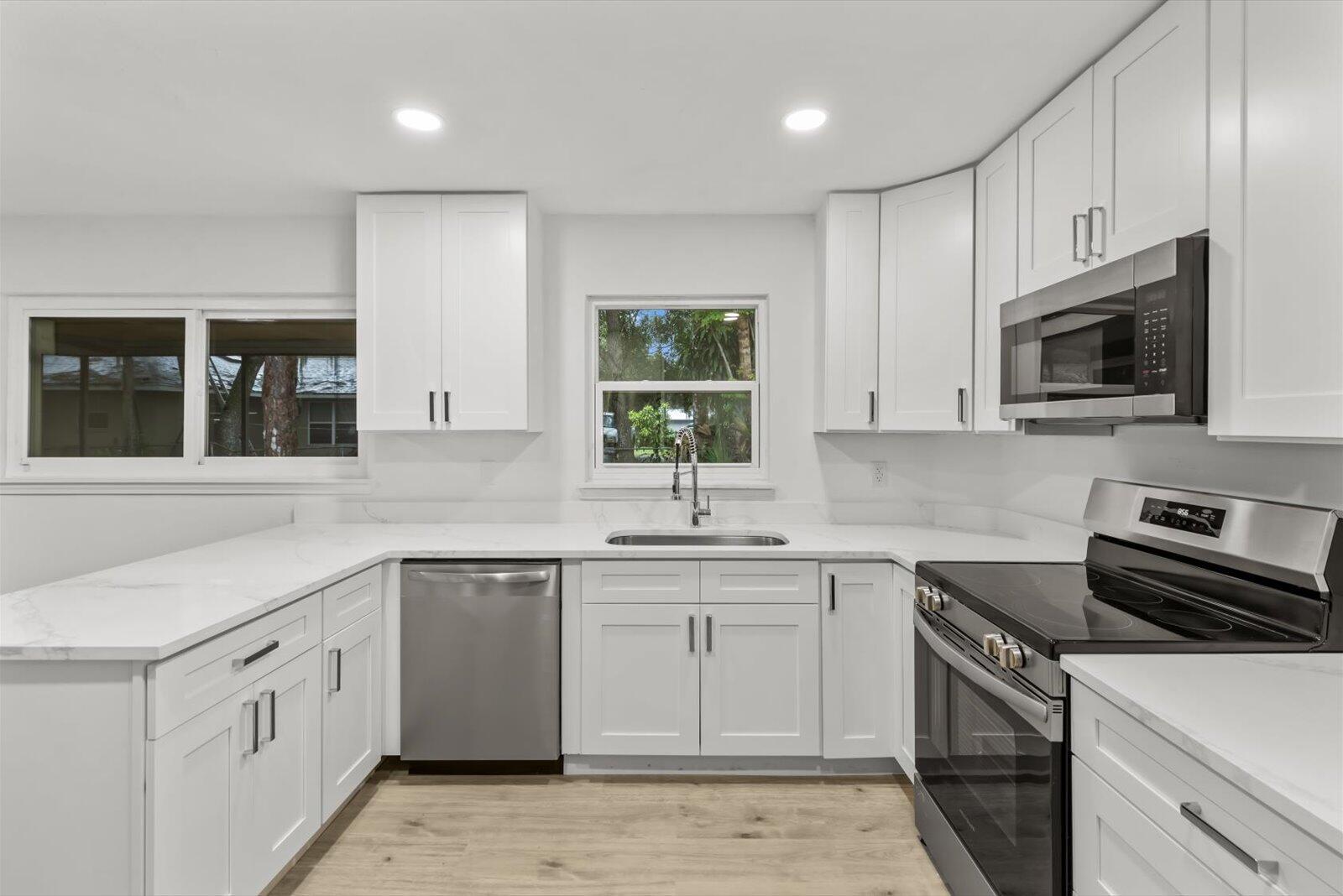 603 Southwest 14th Street Okeechobee, FL 34974 - Photo 2 of 41 a kitchen with a sink stove and microwave