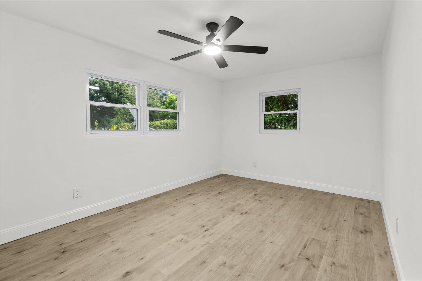603 Southwest 14th Street Okeechobee, FL 34974 - Photo 21 of 41 an empty room with wooden floor and windows