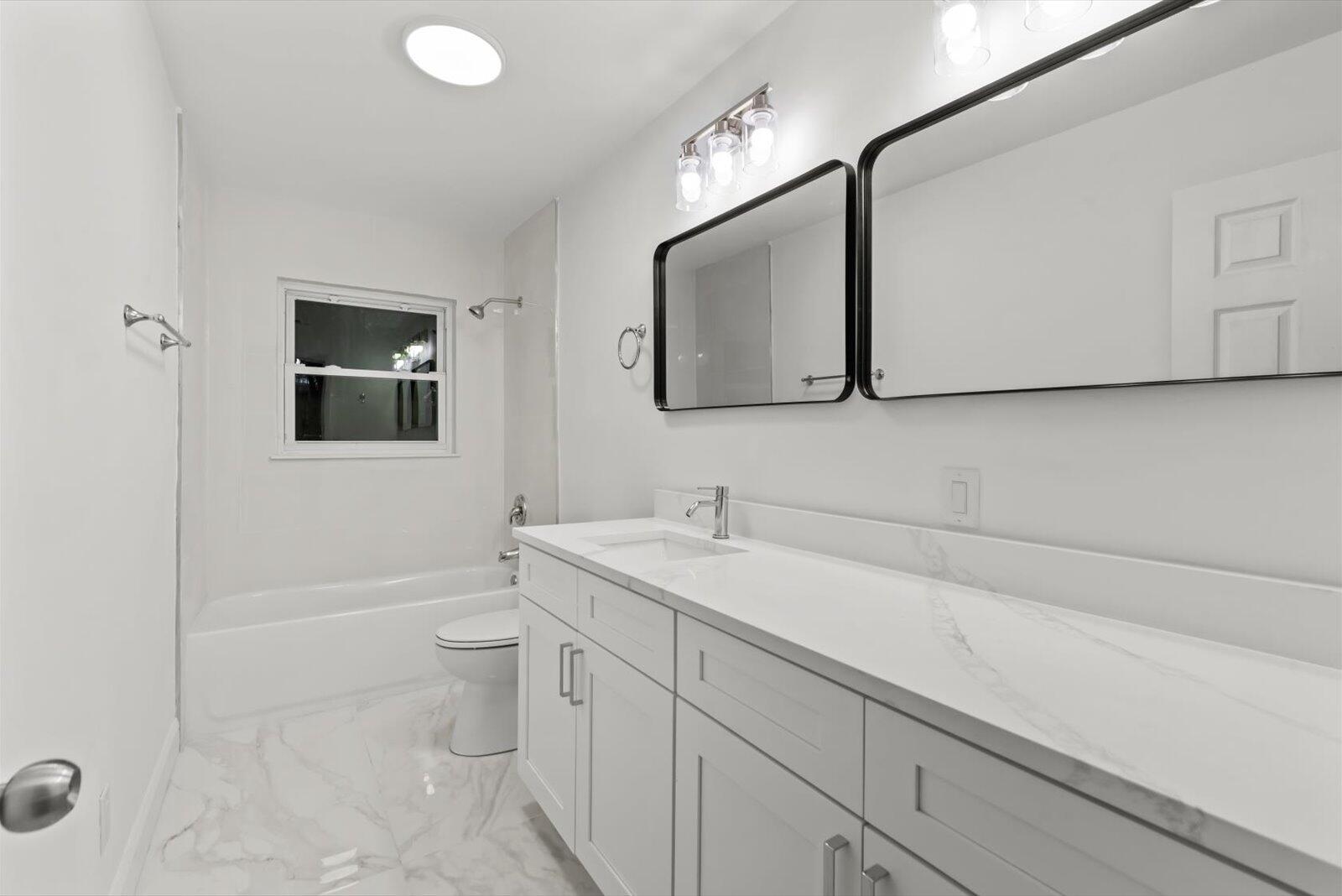 603 Southwest 14th Street Okeechobee, FL 34974 - Photo 23 of 41 a bathroom with a sink a toilet and mirror