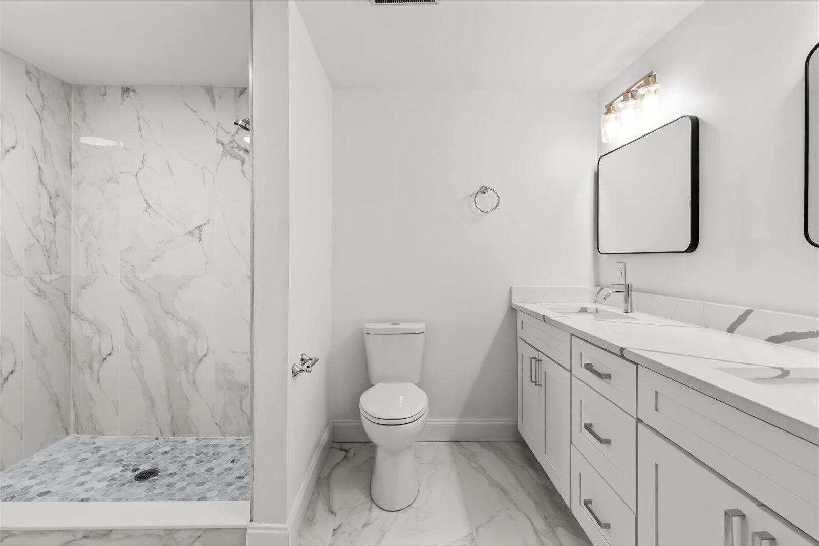 603 Southwest 14th Street Okeechobee, FL 34974 - Photo 3 of 41 a spacious bathroom with a granite countertop sink a toilet and a mirror