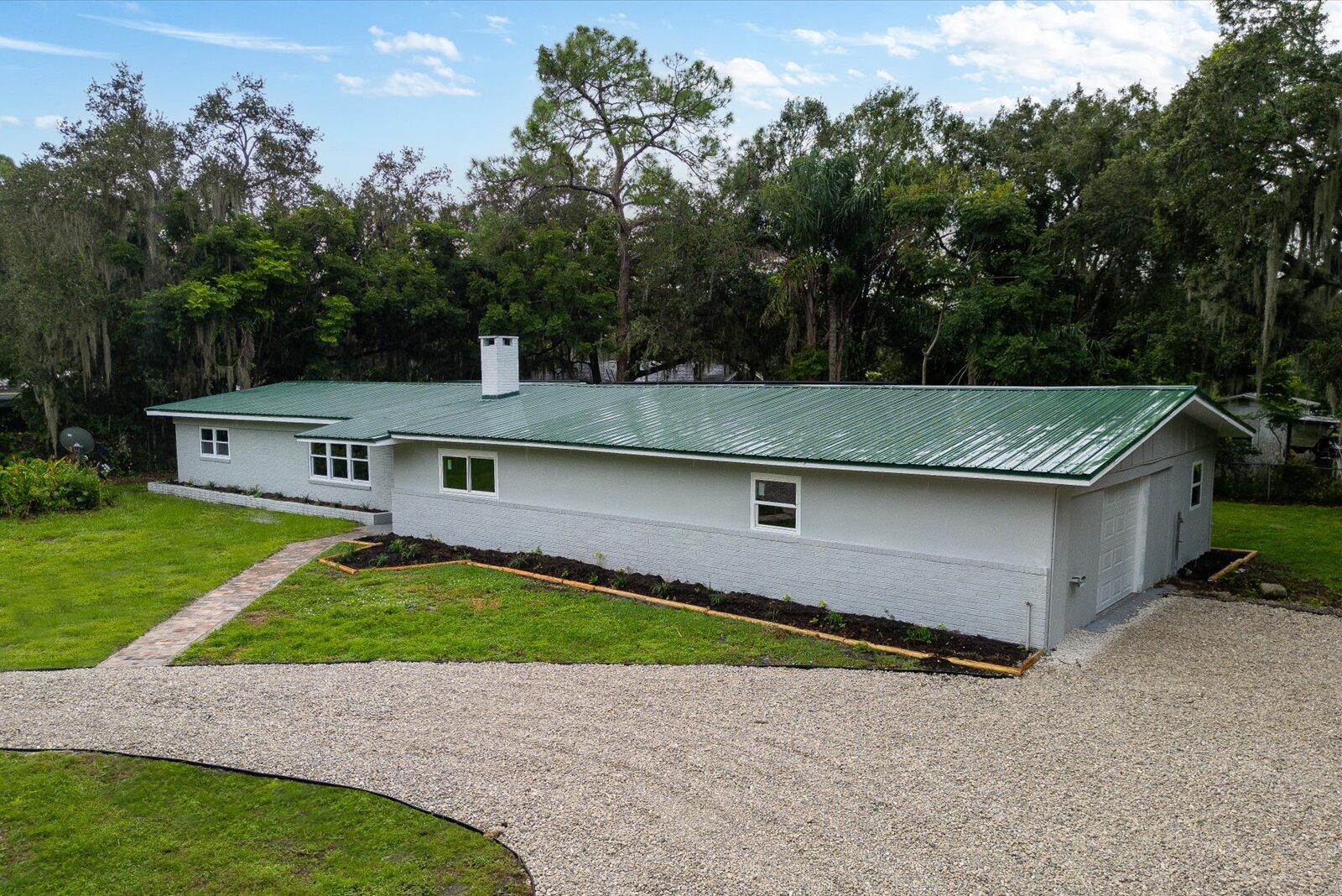 603 Southwest 14th Street Okeechobee, FL 34974 - Photo 4 of 41 an aerial view of a house with a yard and a garage