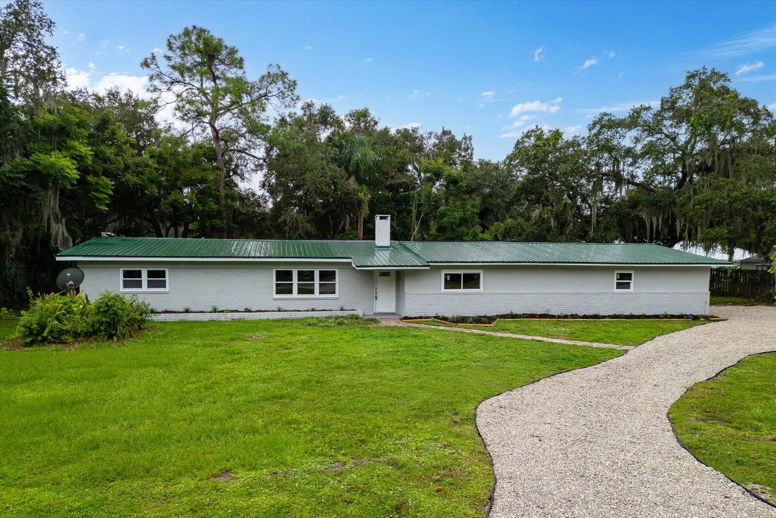 603 Southwest 14th Street Okeechobee, FL 34974 - Photo 5 of 41 front view of a house with a yard