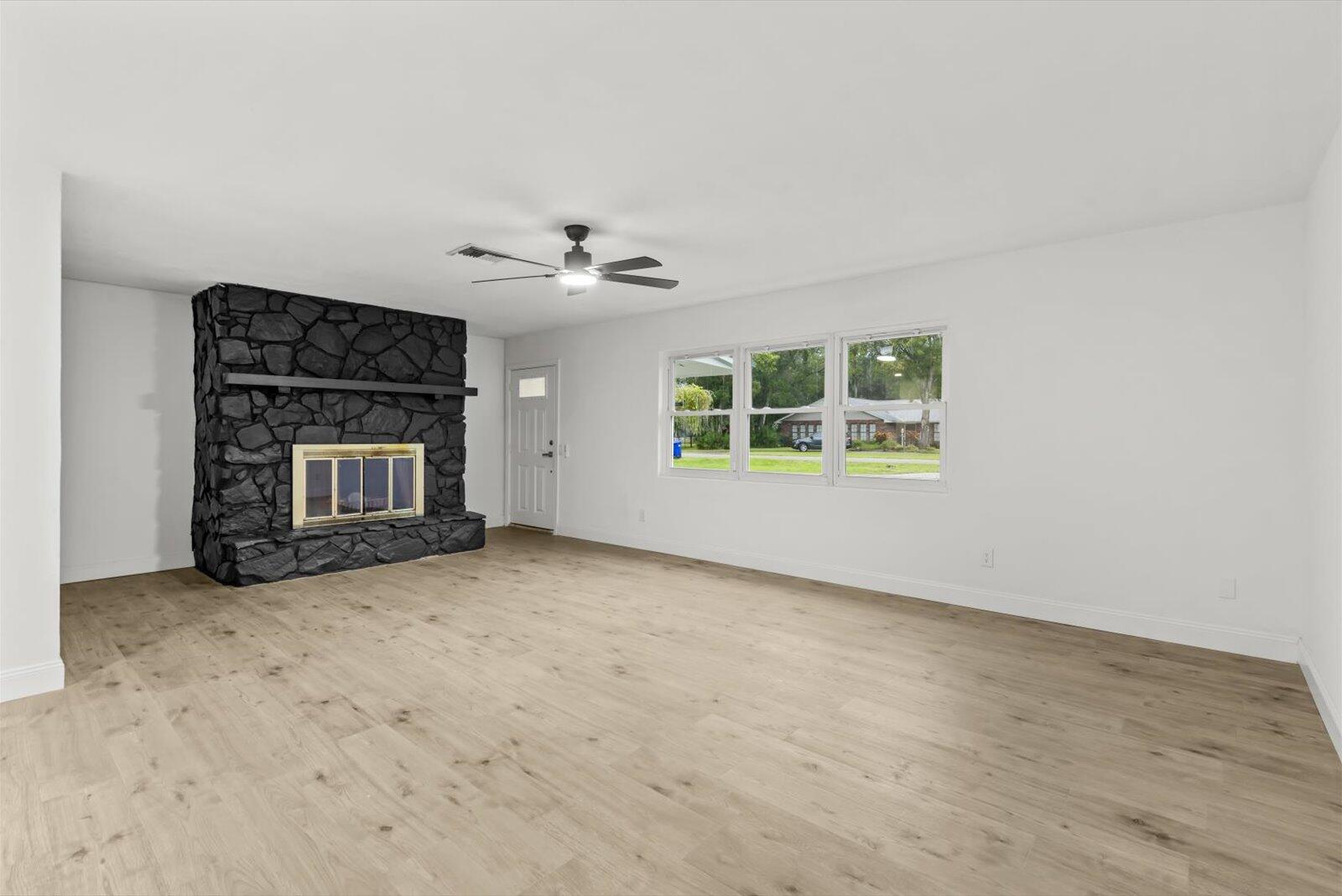 603 Southwest 14th Street Okeechobee, FL 34974 - Photo 9 of 41 an empty room with windows and fireplace