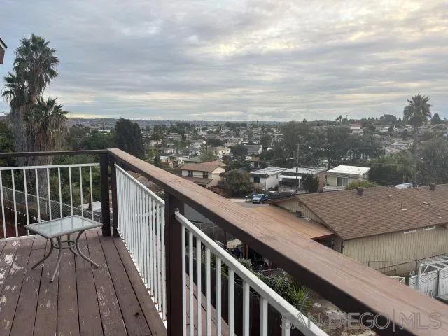 a view of a balcony with an outdoor seating