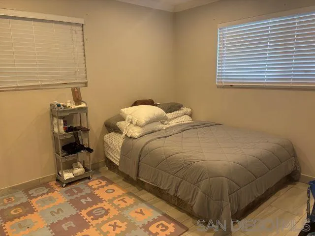 944 Maya Street Spring Valley, CA 91977 - Photo 16 of 20 a bed sitting in a bedroom next to a window