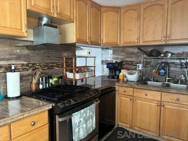 944 Maya Street Spring Valley, CA 91977 - Photo 2 of 20 a kitchen with granite countertop a stove sink and cabinets