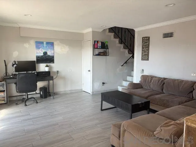 944 Maya Street Spring Valley, CA 91977 - Photo 7 of 20 a living room with furniture and a wooden floor