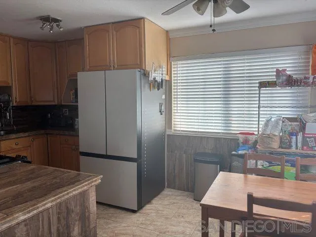 944 Maya Street Spring Valley, CA 91977 - Photo 8 of 20 a kitchen with stainless steel appliances granite countertop a refrigerator and a stove