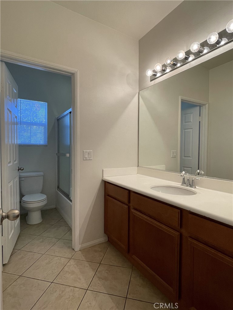 1488 Springfield Way Upland, CA 91786 - Photo 14 of 16 a bathroom with a toilet sink and mirror