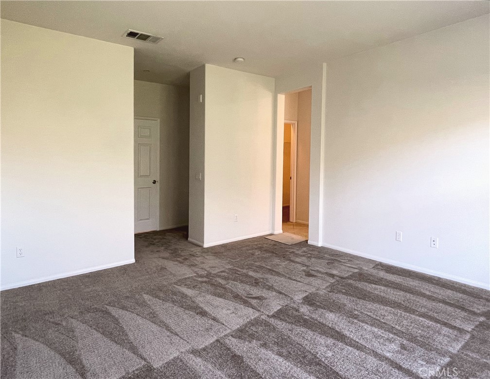 1488 Springfield Way Upland, CA 91786 - Photo 15 of 16 a view of a room with a ceiling fan and wooden floor