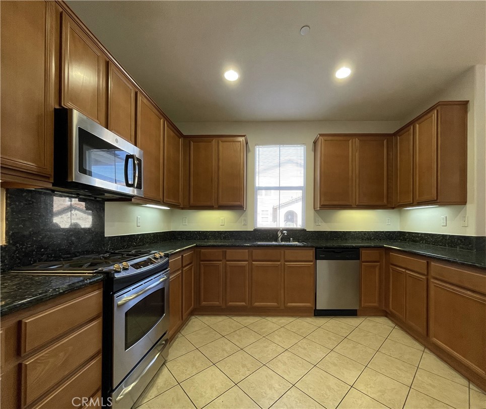 1488 Springfield Way Upland, CA 91786 - Photo 9 of 16 a kitchen with cabinets a sink and appliances