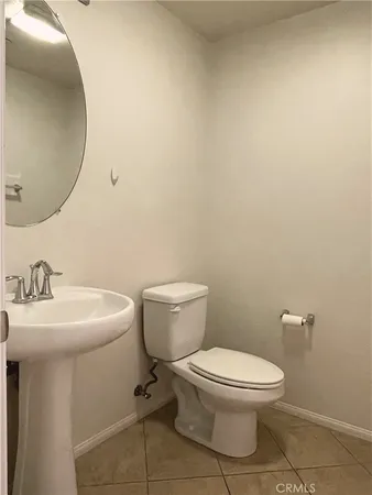 a white toilet sitting next to a bathroom sink