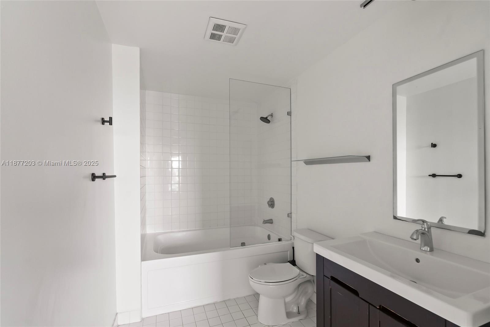 10 Southwest South River Drive, Unit 1006 Miami, FL 33130 - Photo 11 of 16 a bathroom with a sink a toilet and shower