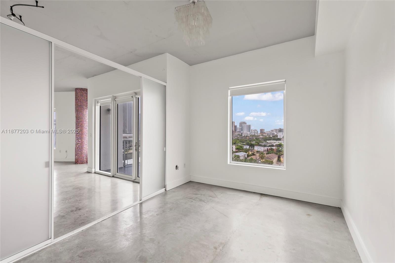 10 Southwest South River Drive, Unit 1006 Miami, FL 33130 - Photo 8 of 16 an empty room with windows and closet