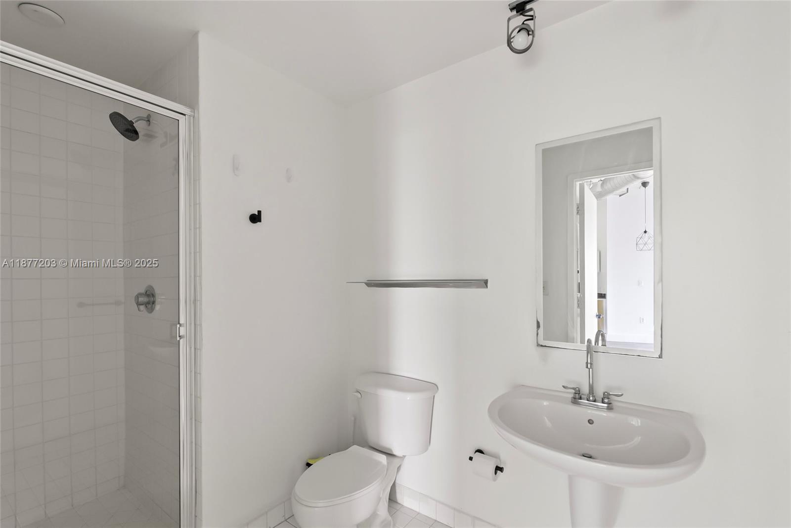 10 Southwest South River Drive, Unit 1006 Miami, FL 33130 - Photo 10 of 16 a bathroom with a sink toilet and shower