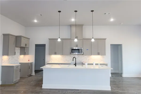 a large kitchen with stainless steel appliances kitchen island a large island in the center