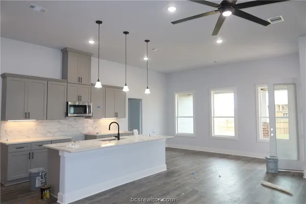 a kitchen with a sink cabinets and window