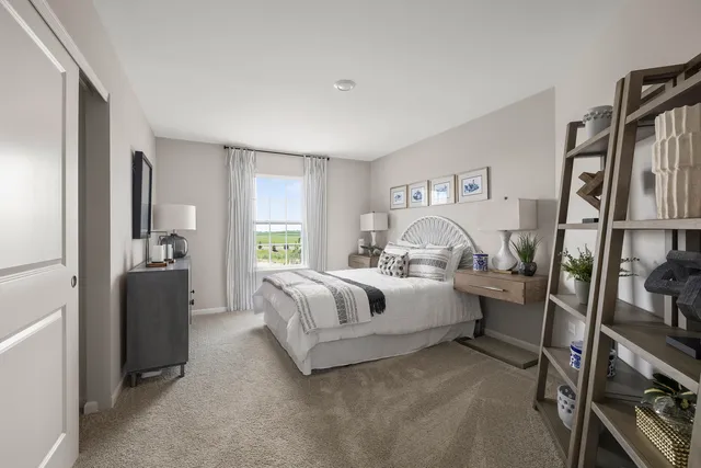 a bedroom with bed and a large window