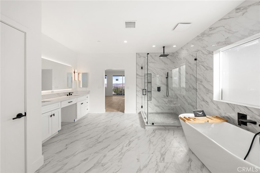 3704 Howe Street Corona, CA 92881 - Photo 11 of 26 a large bathroom with a tub a sink shower and view living room