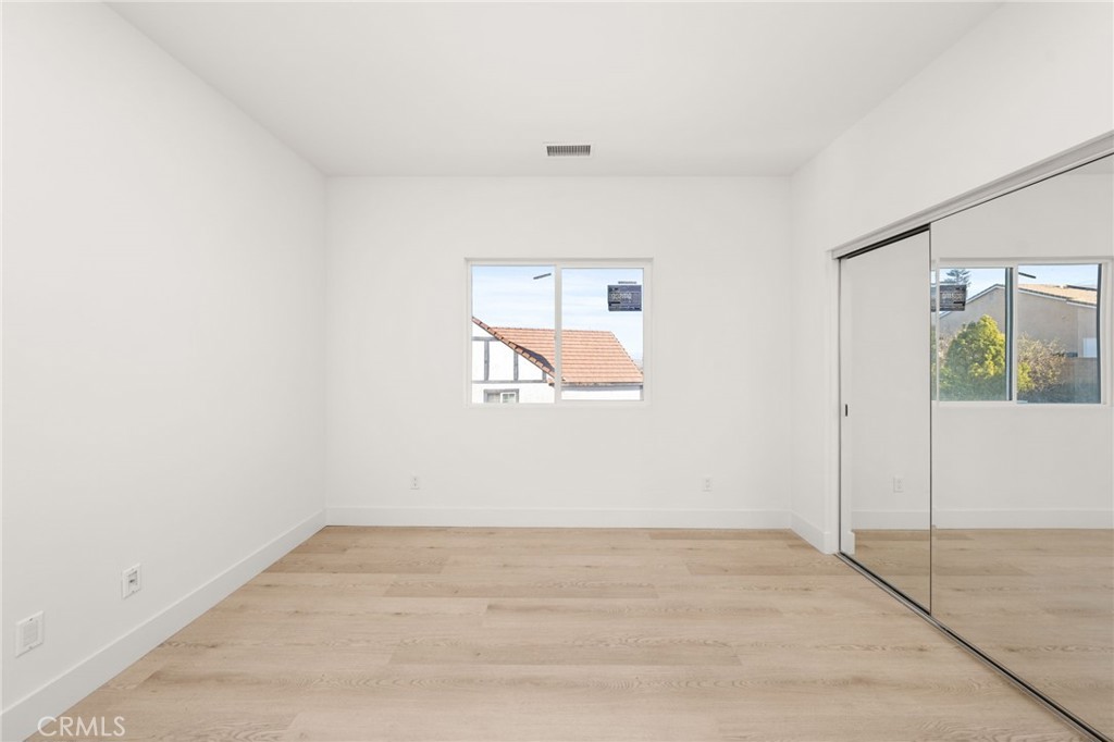 3704 Howe Street Corona, CA 92881 - Photo 13 of 26 an empty room with wooden floor and windows