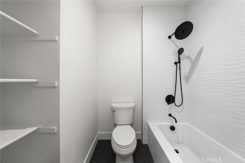 3704 Howe Street Corona, CA 92881 - Photo 14 of 26 a bathroom with a toilet and a tub