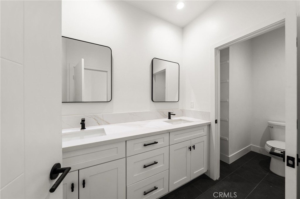 3704 Howe Street Corona, CA 92881 - Photo 16 of 26 a bathroom with a double vanity sink and mirror