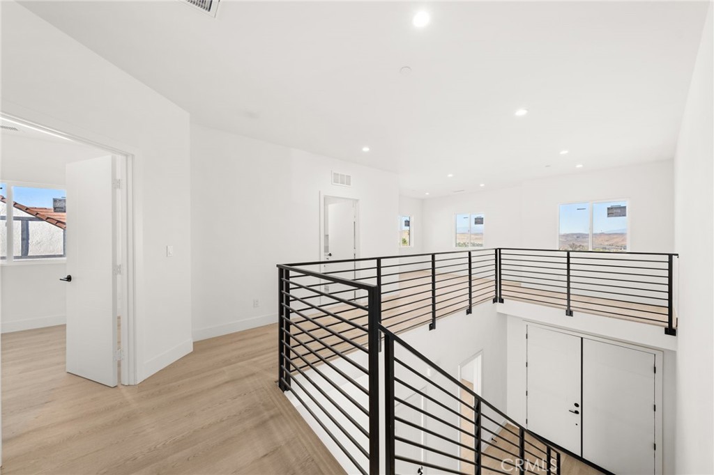 3704 Howe Street Corona, CA 92881 - Photo 19 of 26 a view of a hallway with stairs and wooden floor
