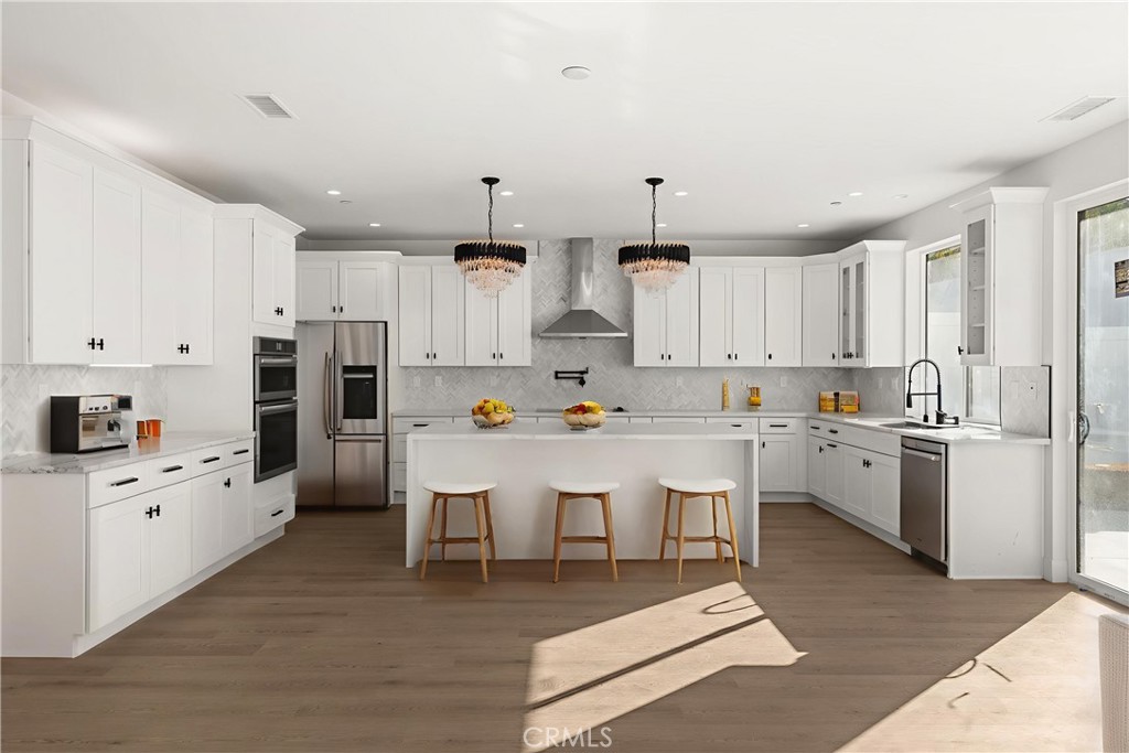 3704 Howe Street Corona, CA 92881 - Photo 2 of 26 a kitchen with white cabinets and stainless steel appliances