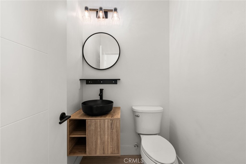 3704 Howe Street Corona, CA 92881 - Photo 8 of 26 a bathroom with a toilet and a mirror