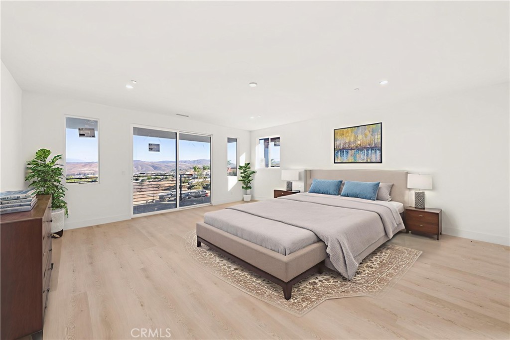 3704 Howe Street Corona, CA 92881 - Photo 10 of 26 a spacious bedroom with a large bed and a potted plant