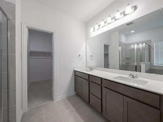 a bathroom with a sink double vanity and a mirror